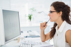 36327284 - focused businesswoman with glasses using computer in the office