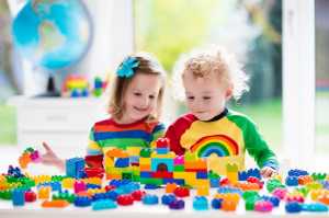 Kids playing with colorful plastic blocks